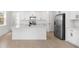Elegant kitchen with white cabinets, stainless steel appliances, quartz countertops, and tile flooring at 6038 Jensen View Ave, Apollo Beach, FL 33572