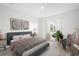 Stylishly furnished main bedroom showcasing a large window with natural light at 6038 Jensen View Ave, Apollo Beach, FL 33572