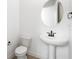 Elegant powder room featuring modern fixtures and a pedestal sink at 6038 Jensen View Ave, Apollo Beach, FL 33572