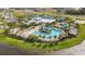 Aerial view of a community pool, playground, clubhouse, tennis courts, and other community amenities at 6042 Jensen View Ave, Apollo Beach, FL 33572