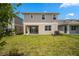 Spacious backyard with lush green grass and a covered patio for outdoor living at 6042 Jensen View Ave, Apollo Beach, FL 33572