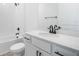 Modern white bathroom featuring sleek fixtures, a shower-tub combo, and stylish vanity with black hardware at 6042 Jensen View Ave, Apollo Beach, FL 33572