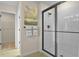 Modern bathroom featuring a glass-enclosed shower with white subway tile and neutral wall decor at 6042 Jensen View Ave, Apollo Beach, FL 33572