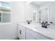 Clean and modern bathroom with double sinks, quartz counters, and bright natural light at 6042 Jensen View Ave, Apollo Beach, FL 33572
