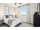 Bright, carpeted bedroom featuring neutral colors, large window, and a view of the yard beyond at 6042 Jensen View Ave, Apollo Beach, FL 33572