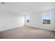 Spacious bedroom with neutral carpeting, large windows, and abundant natural light, ready for personal touches at 6042 Jensen View Ave, Apollo Beach, FL 33572