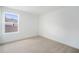 Bright bedroom with neutral carpet, white walls, and a large window at 6042 Jensen View Ave, Apollo Beach, FL 33572