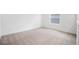 Carpeted bedroom showcasing ample space and natural light, enhanced by modern aesthetics and design at 6042 Jensen View Ave, Apollo Beach, FL 33572