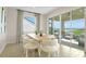 Bright dining area with table set for six, large sliding doors offer a scenic view of the outdoor seating area at 6042 Jensen View Ave, Apollo Beach, FL 33572