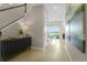 Hallway with wood-look floors leading to dining area and staircase showcasing an open concept design at 6042 Jensen View Ave, Apollo Beach, FL 33572