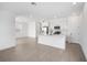 Open-concept kitchen features white cabinets, stainless appliances, and island with bar seating at 6042 Jensen View Ave, Apollo Beach, FL 33572