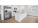 Modern kitchen featuring white cabinets, stainless steel appliances, and an island with seating at 6042 Jensen View Ave, Apollo Beach, FL 33572