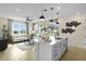 Open-concept kitchen with a view of the living room, white cabinetry, and quartz countertop island at 6042 Jensen View Ave, Apollo Beach, FL 33572