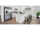 Modern kitchen featuring white cabinets, stainless steel appliances, and an island with seating at 6042 Jensen View Ave, Apollo Beach, FL 33572