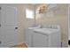 Laundry room with washer, dryer, wire shelving for storage, and a window for natural light at 6042 Jensen View Ave, Apollo Beach, FL 33572