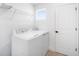 Bright laundry room with modern washer and dryer, storage, and tile floors, perfect for functionality at 6042 Jensen View Ave, Apollo Beach, FL 33572