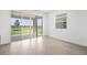 Bright living room with tile floors and large sliding glass doors leading to the backyard at 6042 Jensen View Ave, Apollo Beach, FL 33572
