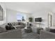 Bright living room with neutral decor, large windows, and stylish furniture for a modern, inviting space at 6042 Jensen View Ave, Apollo Beach, FL 33572