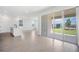 Bright living room with tile floors and large sliding glass doors leading to the backyard at 6042 Jensen View Ave, Apollo Beach, FL 33572
