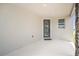 Covered porch with a modern front door featuring vertical window panes at 6042 Jensen View Ave, Apollo Beach, FL 33572