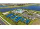 Stunning aerial view of community amenities including a pool, sports courts, playground, and lakeside scenery at 6046 Jensen View Ave, Apollo Beach, FL 33572