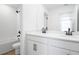Modern bathroom with double sinks, white cabinets, a tub shower combo, and black hardware at 6046 Jensen View Ave, Apollo Beach, FL 33572