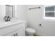 Modern bathroom with white vanity, quartz countertop, black fixtures, and a glass-enclosed shower at 6046 Jensen View Ave, Apollo Beach, FL 33572
