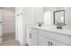 Elegant bathroom with double sinks, quartz countertop, black hardware, and walk-in closet at 6046 Jensen View Ave, Apollo Beach, FL 33572