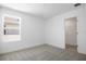 Bright bedroom with neutral carpet, a window for natural light, and a closet space at 6046 Jensen View Ave, Apollo Beach, FL 33572
