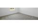 A minimalist bedroom featuring plush carpeting, natural light from the window, and a clean, uncluttered design at 6046 Jensen View Ave, Apollo Beach, FL 33572