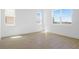 Spacious bedroom with neutral paint, large windows, and wood-look tile flooring for a clean aesthetic at 6046 Jensen View Ave, Apollo Beach, FL 33572