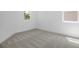 Cozy bedroom with neutral carpet, white walls, and bright natural light from two windows at 6046 Jensen View Ave, Apollo Beach, FL 33572