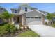 Beautiful two-story home featuring a two-car garage and professionally landscaped front yard at 6046 Jensen View Ave, Apollo Beach, FL 33572