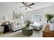 Cozy living room featuring a comfortable sectional sofa, stylish ottoman, and contemporary décor at 6046 Jensen View Ave, Apollo Beach, FL 33572