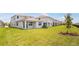 Expansive backyard with well-maintained lawn and view of multiple home exteriors at 6058 Jensen View Ave, Apollo Beach, FL 33572