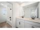 Modern bathroom with double sink vanity, black hardware, and shower-tub combo with tile surround at 6058 Jensen View Ave, Apollo Beach, FL 33572