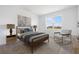 Cozy bedroom with a neutral color scheme, a large window, and stylish decor at 6058 Jensen View Ave, Apollo Beach, FL 33572