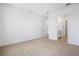 Spacious bedroom with neutral carpeting and an open view of a secondary bath and closet at 6058 Jensen View Ave, Apollo Beach, FL 33572
