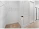 Walk-in closet featuring shelving and door with easy access to bath at 6058 Jensen View Ave, Apollo Beach, FL 33572