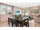 Bright dining area featuring a wooden table and chairs, complemented by natural light and an adjacent living space at 6058 Jensen View Ave, Apollo Beach, FL 33572