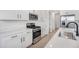 Modern kitchen featuring white cabinets, stainless steel appliances, and a gas range stove at 6058 Jensen View Ave, Apollo Beach, FL 33572
