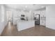 Modern kitchen featuring white cabinets, a kitchen island, stainless steel appliances, and tile flooring at 6058 Jensen View Ave, Apollo Beach, FL 33572