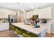 Modern kitchen with large island, stainless steel appliances, and white cabinets at 6058 Jensen View Ave, Apollo Beach, FL 33572