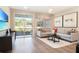 Inviting living room with a modern sofa, sliding glass doors, and contemporary decor at 6058 Jensen View Ave, Apollo Beach, FL 33572