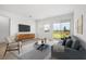 Comfortable living room showcasing contemporary furnishings and large windows with backyard views at 6058 Jensen View Ave, Apollo Beach, FL 33572