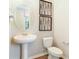 Powder room with pedestal sink and decorative wall art at 6058 Jensen View Ave, Apollo Beach, FL 33572