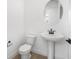 Well-lit powder room with pedestal sink, tile flooring, and modern fixtures at 6058 Jensen View Ave, Apollo Beach, FL 33572