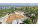 Aerial view of a splash pad with various water features, play areas, and shaded seating areas, ideal for families at 6058 Jensen View Ave, Apollo Beach, FL 33572