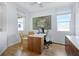Office space featuring two windows, tile floors, modern furniture, and art decorating the white walls at 6062 Jensen View Ave, Apollo Beach, FL 33572