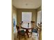 Cozy dining area with a round wooden table, chairs, and natural light from a window at 8728 Mallard Reserve Dr # 103, Tampa, FL 33614